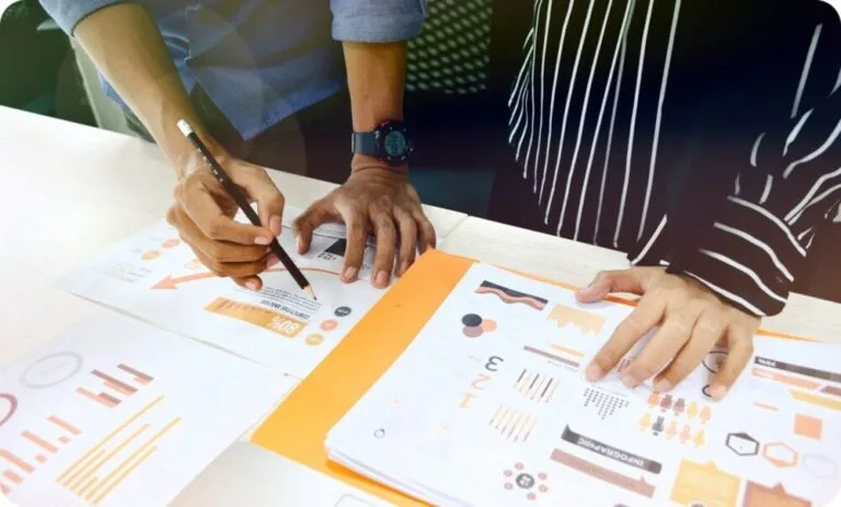 CMA 자격증 취득을 위한 CMA 자격요건 가이드 1 two people having a business meeting with a pencil and paper reports