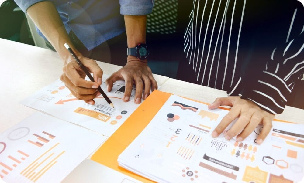 two people having a business meeting with a pencil and paper reports