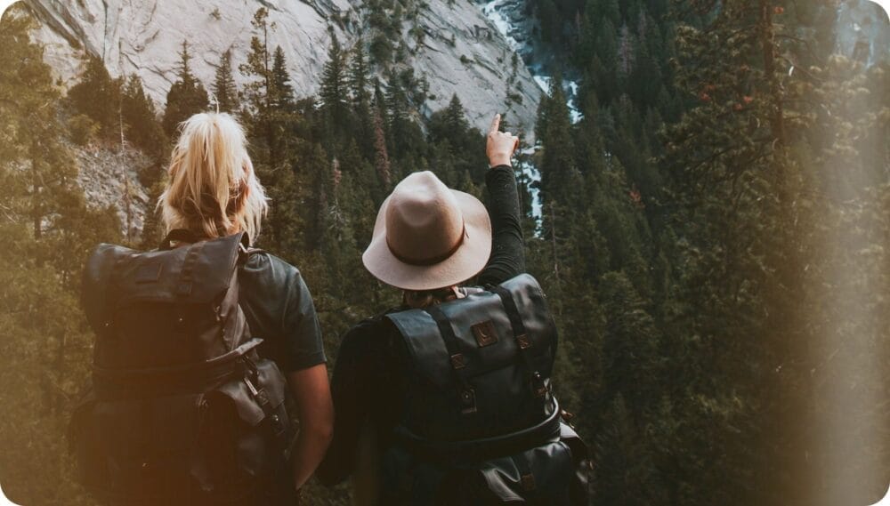 two people looking and pointing mountains