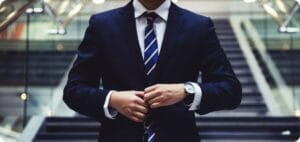 a businessman on the stairs in a building wearing a suit and tie
