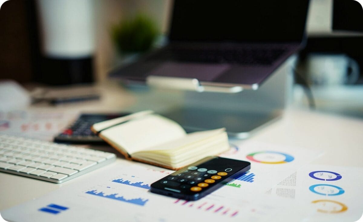 notebook and calculators on financial reports in a desktop setup