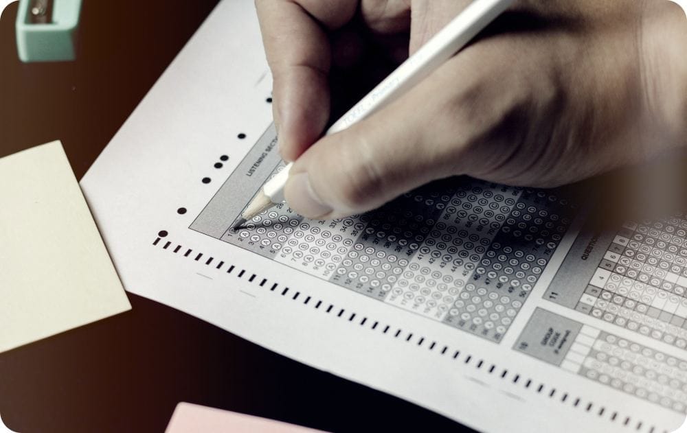 Taking a multiple choice exam on a white paper with a pencil