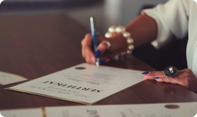 a woman signing on a professional certificate