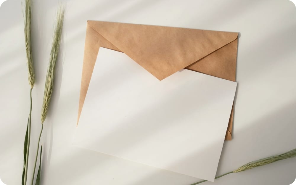 a white blank paper on a brown envelope on a desk