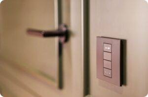 a light switch on a wall next to a door of a room