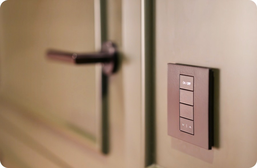 a light switch on a wall next to a door of a room