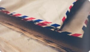 White mailing envelopes on a pile of papers