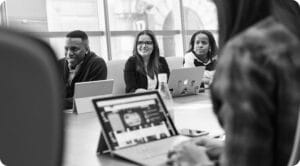 people sitting at a table having a meeting
