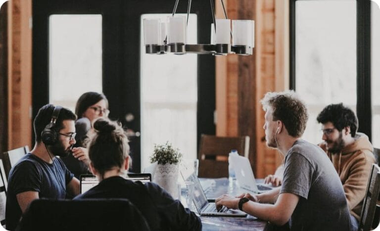 People sitting at a study table in a room