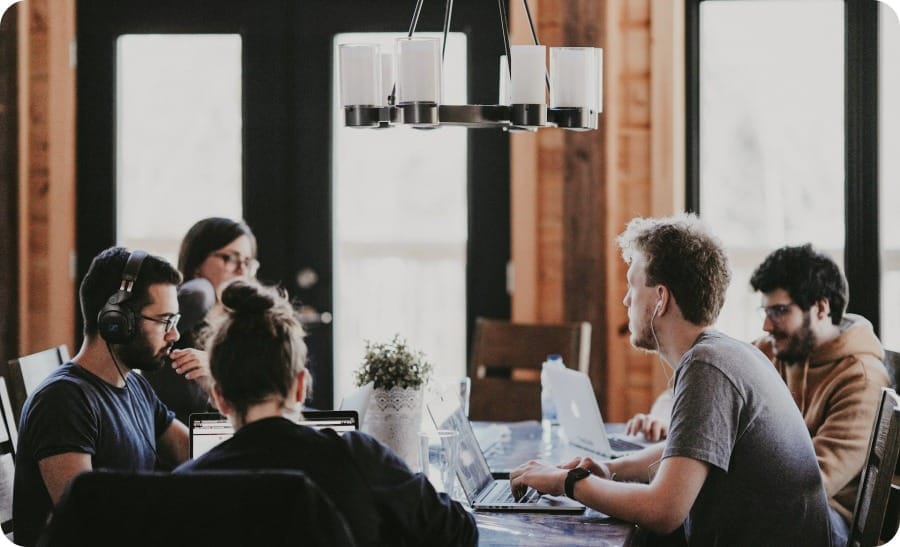 People sitting at a study table in a room