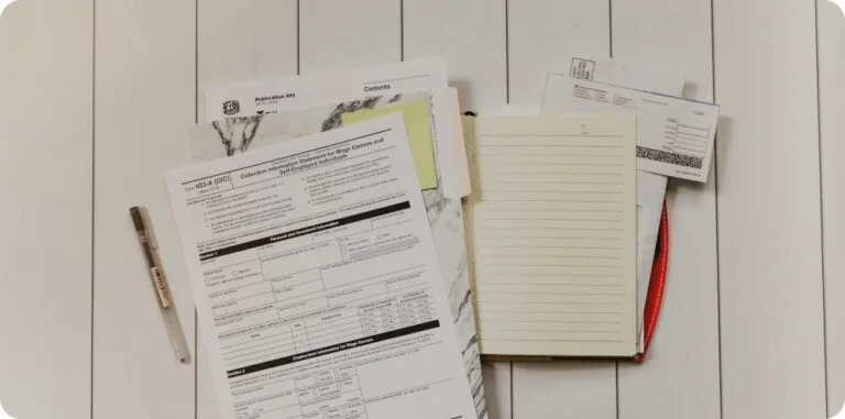 ITIN 발급 받는 법: 신청 방법 및 소요 기간, 발급 비용 15 a stack of tax documents and note laying on a ground next to a pen