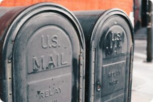 two gray U.S. mailboxes next to each other