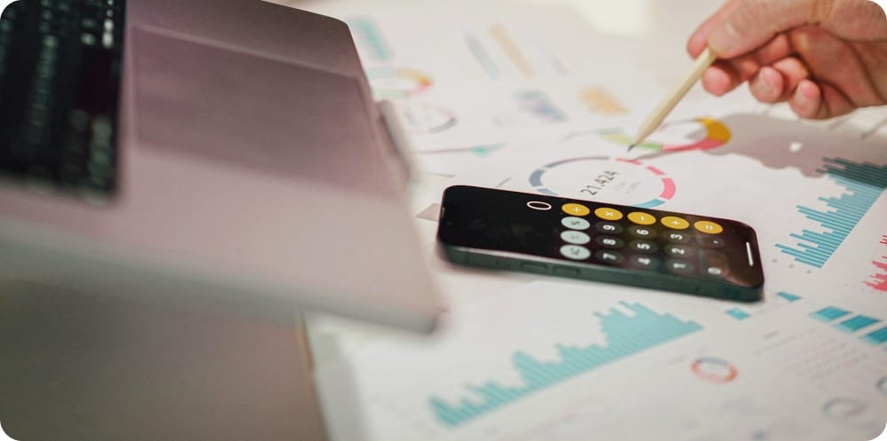 a calculator and financial analysis reports on a table
