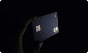 a hand holding a credit card in black