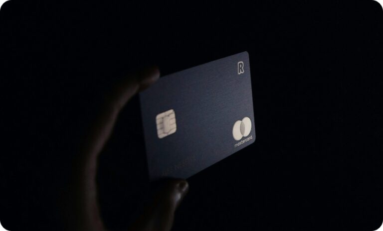 a hand holding a credit card in black