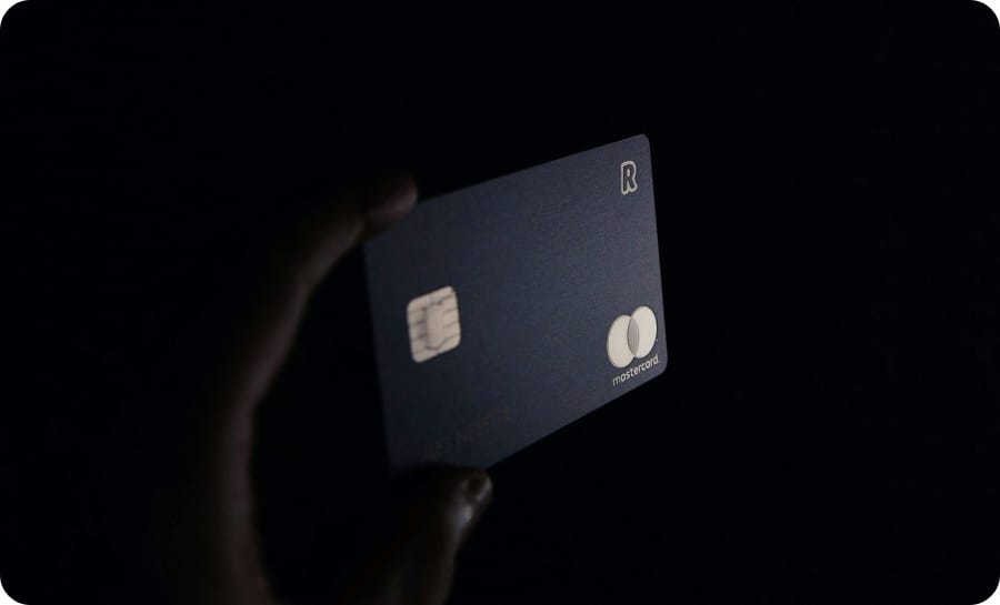 a hand holding a credit card in black